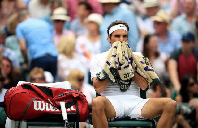 Roger Federer rests between games