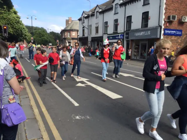 Crowds walking down road in Cardiff