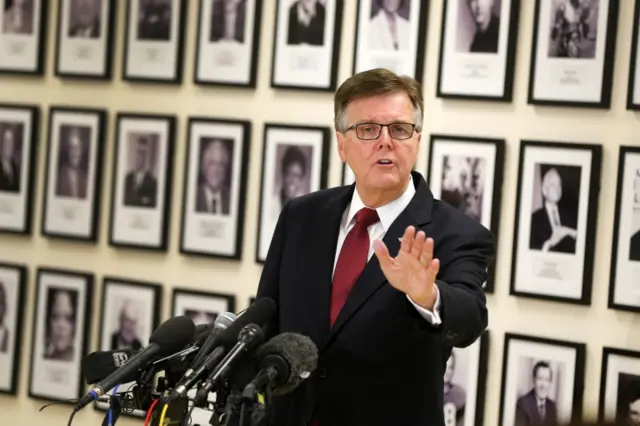 Texas Lt. Gov. Dan Patrick, standing in front of the Fort Worth ISD Legacy of Excellence wall,