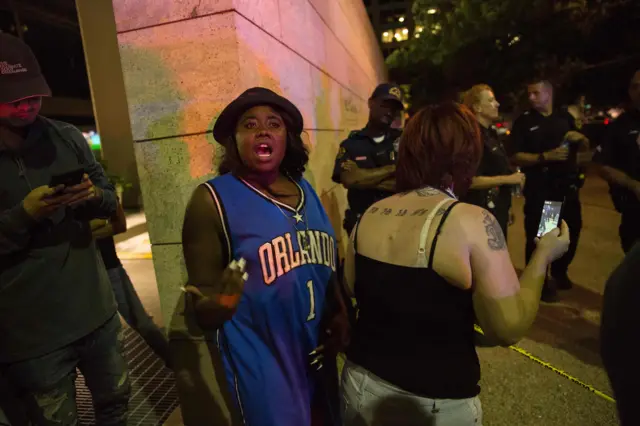 Protesters at the scene following the shootings