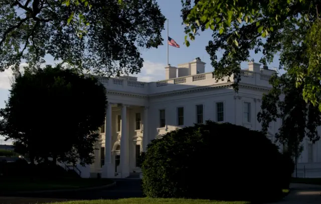 The American flag flies at half-staff over the White House in Washington