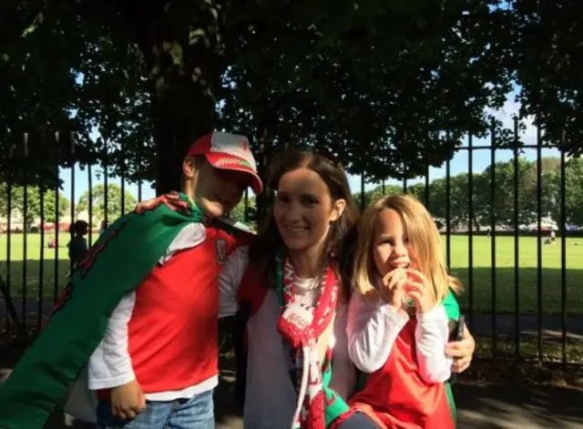 Little Osian and Nia, with mum Claire, have turned out to welcome home Wales.