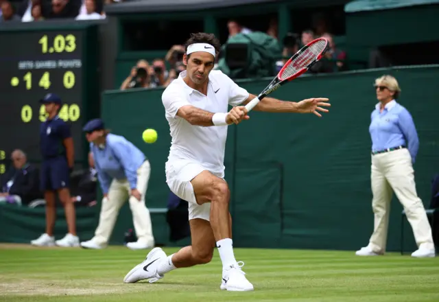 Roger Federer plays a backhand