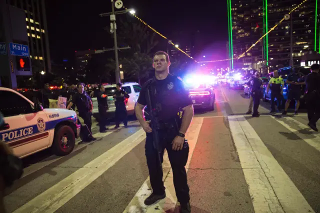 A Police officer stands guard at a barricade