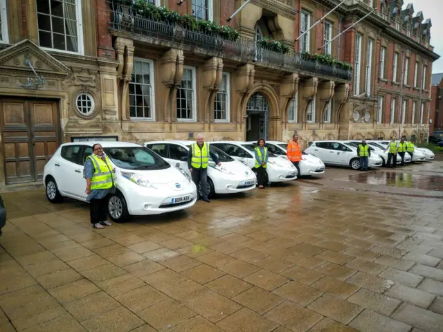 Council workers stood by news cars