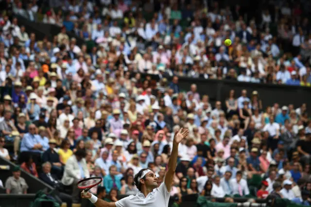 Roger Federer serves