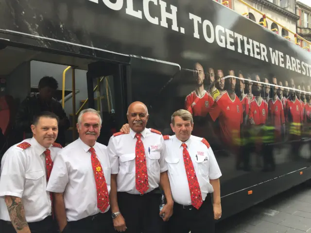 Bus staff in front of the open top bus