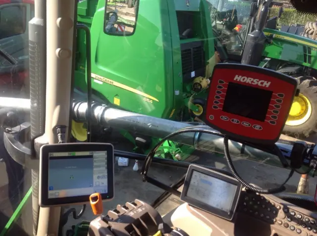 Image showing the interior of a tractor cab with GPS technology.