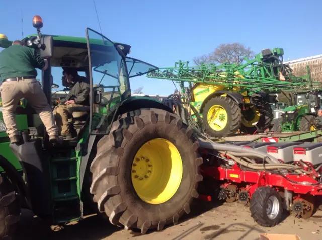 Picture of farm machinery, including a tractor being checked over by rural police