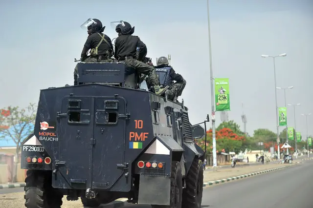 A picture taken on April 18, 2011 shows Nigerian police enforcing a curfew in the capital of Bauchi state, nothern Nigeria, after riots, run by muslim youth, broke out in Bauchi.