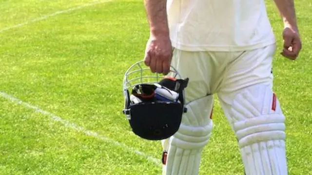 Man walking off a cricket pitch