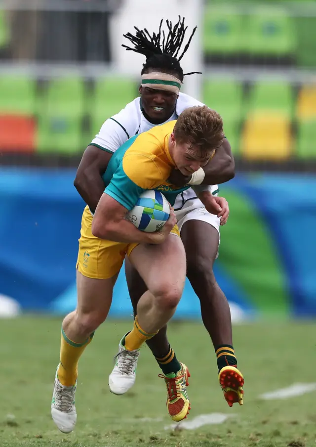 Henry Hutchison of Australia is tackled by Seabelo Senatla of South Africa