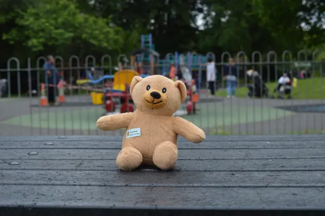 Teddy bear by a children's playground