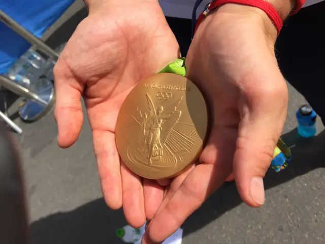 Joe Clarke hands and medal