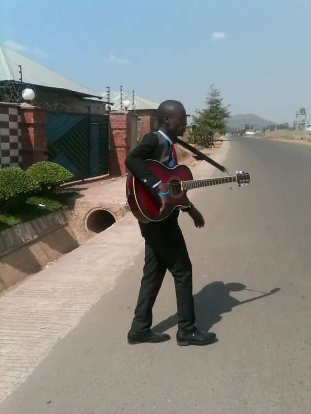 Suited man with guitar