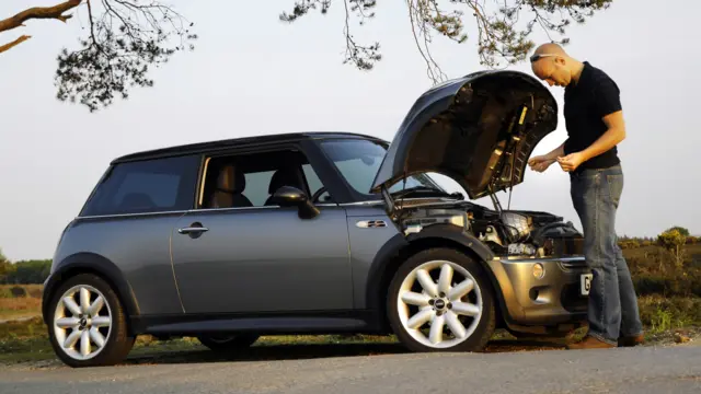 Man with broken down car