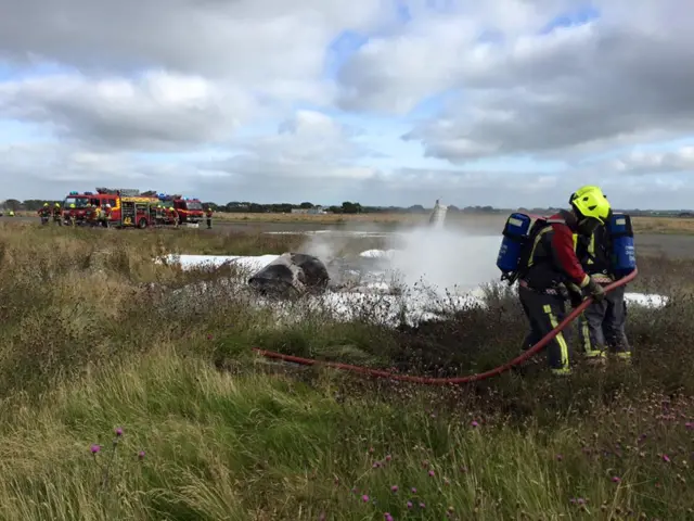 Fire crew putting out plane fire