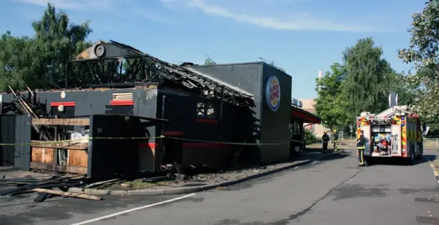 Firefighters at Burger King, which is severely damaged