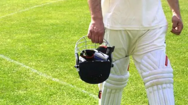 Cricketer walking off pitch