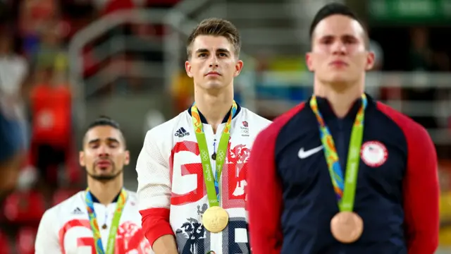 Max stands on podium to receive gold medal