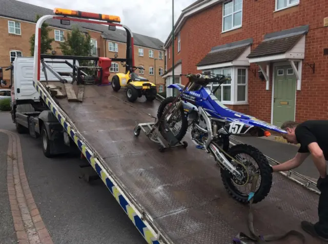 Bikes being loaded onto police recovery vehicles