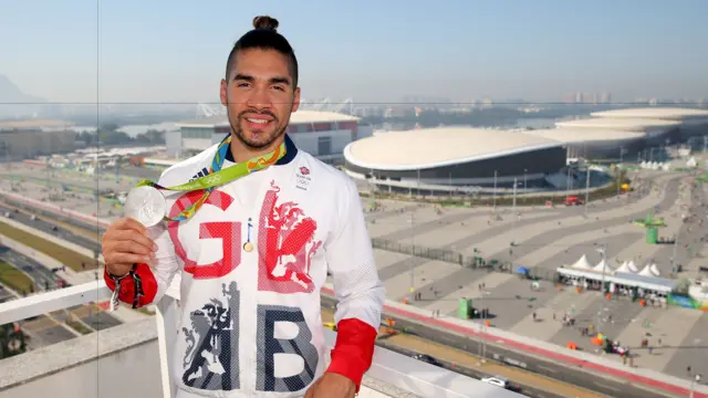 Louis Smith holds his silver medal