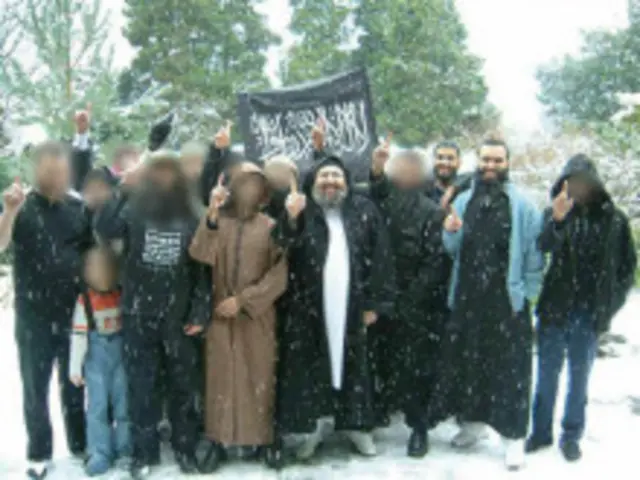 Khan (in black) and Alamgir (in blue cardigan) with Omar Bakri Muhammed