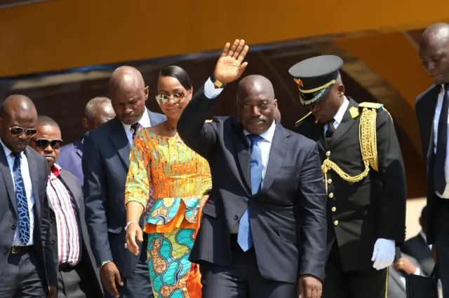 Congolese President Joseph Kabila, center, waves as he and others celebrate the Democratic Republic of Congo, DRC, independence in Kindu, Congo, Thursday, June 30, 2016