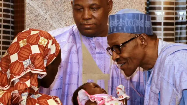 Amina Ali Nkeki with her daughter and President Buhari