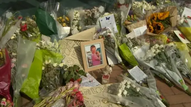 Flowers and photo of Ethan outside All Saints Academy