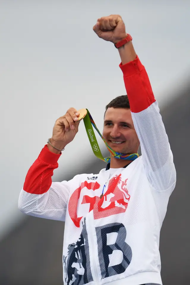 Giles Scott holding his gold medal