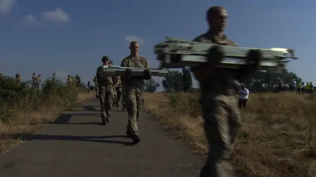 Soldiers carrying flood defences