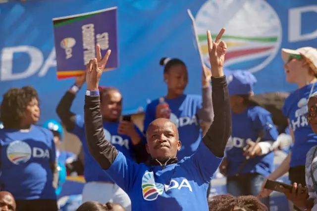 Supporters gather and cheer as Leader of South Africa"s opposition Democratic Alliance (DA) party, Mmusi Maimane, is seen addressing some of the thousands of people who attended the parties final pre election rally in Soweto, Johannesburg , South Africa, 30 July 2016