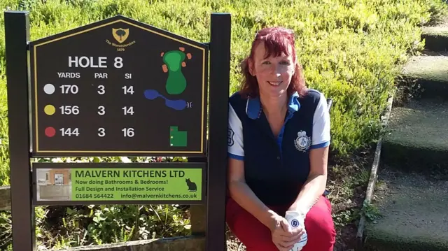 Woman golfer and sign