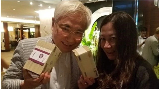 Japanese plastic surgeon Katsuya Takasu (left) with his "special donation" to the Nigerian team in Rio