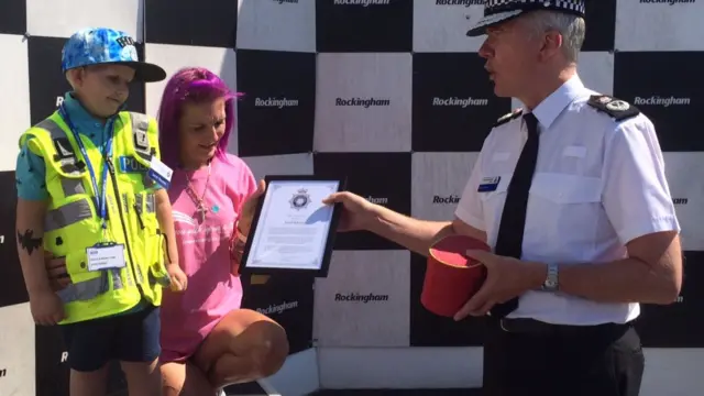 Jacob is presented with a certificate by the police
