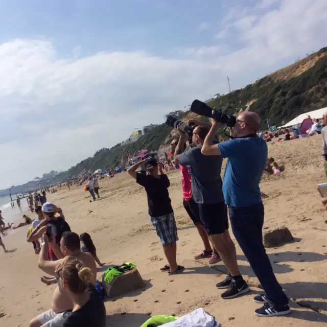 People taking photographs on Bournemouth Beach