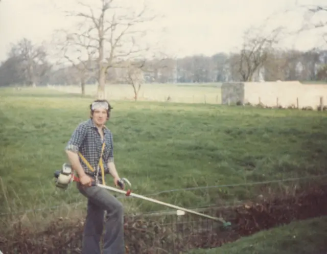 Philip Whaites strimmering in the gardens in 1982