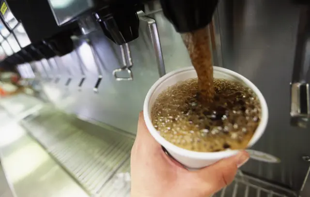 Sparking soft drink being poured