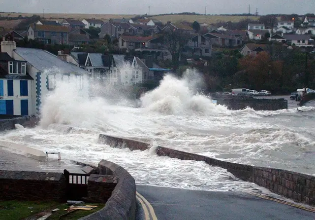 A giant wave hits the south Cornwall seaside town of Portmellon in 2004