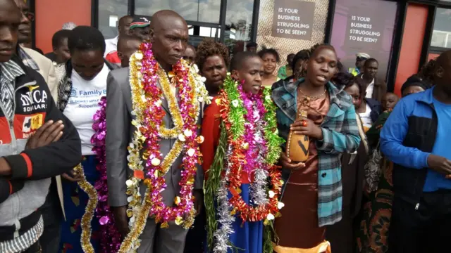 Joel Murei, ruth jebet's father, stands alongside her outside the aiport