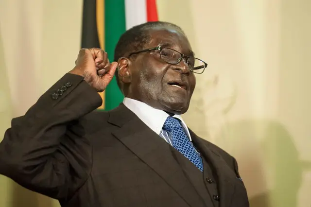 Zimbabwe's President Robert Mugabe clinches his fist while shouting 'Amandla' (Power in Xhosa and Zulu) during the signing of various memorandum of understanding with South Africa at the Union Buildings in Pretoria on April 8, 2015.