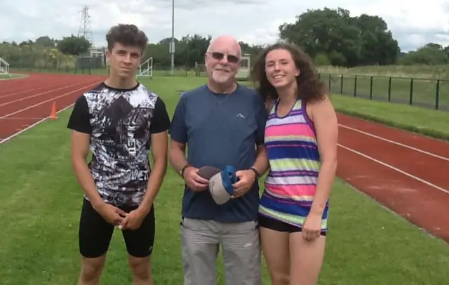 Arnie Wray with athletes Jake Akindutire and Hollie Williamson