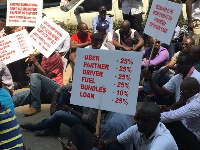 Driver holding a placard