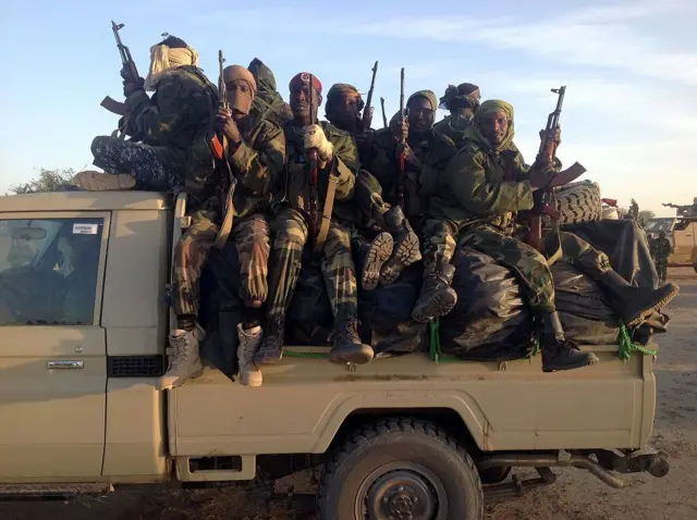 Soldiers of the Chadian army patrol on at the border between Nigeria and Cameroon