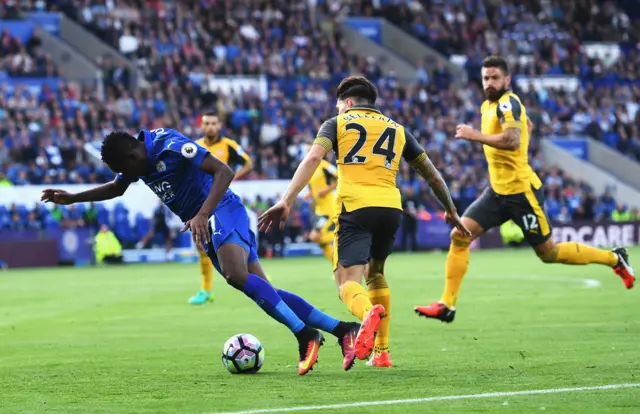 Leicester City's Ahmed Musa goes down in the area