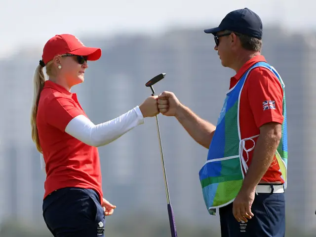 Charley Hull bumps fists with her caddie at the Rio Olympics