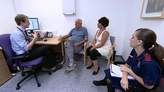 A doctor speaking to a patient