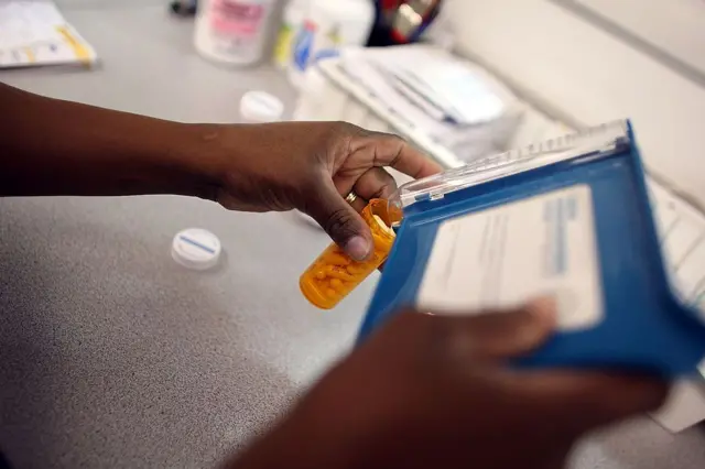 Rosemary Petty, a Publix Supermarket pharmacy technician, counts out a prescription of antibiotic pills August 7, 2007 in Miami, Florida.