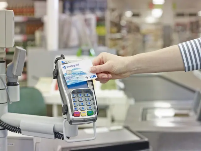 Woman making contactless payment